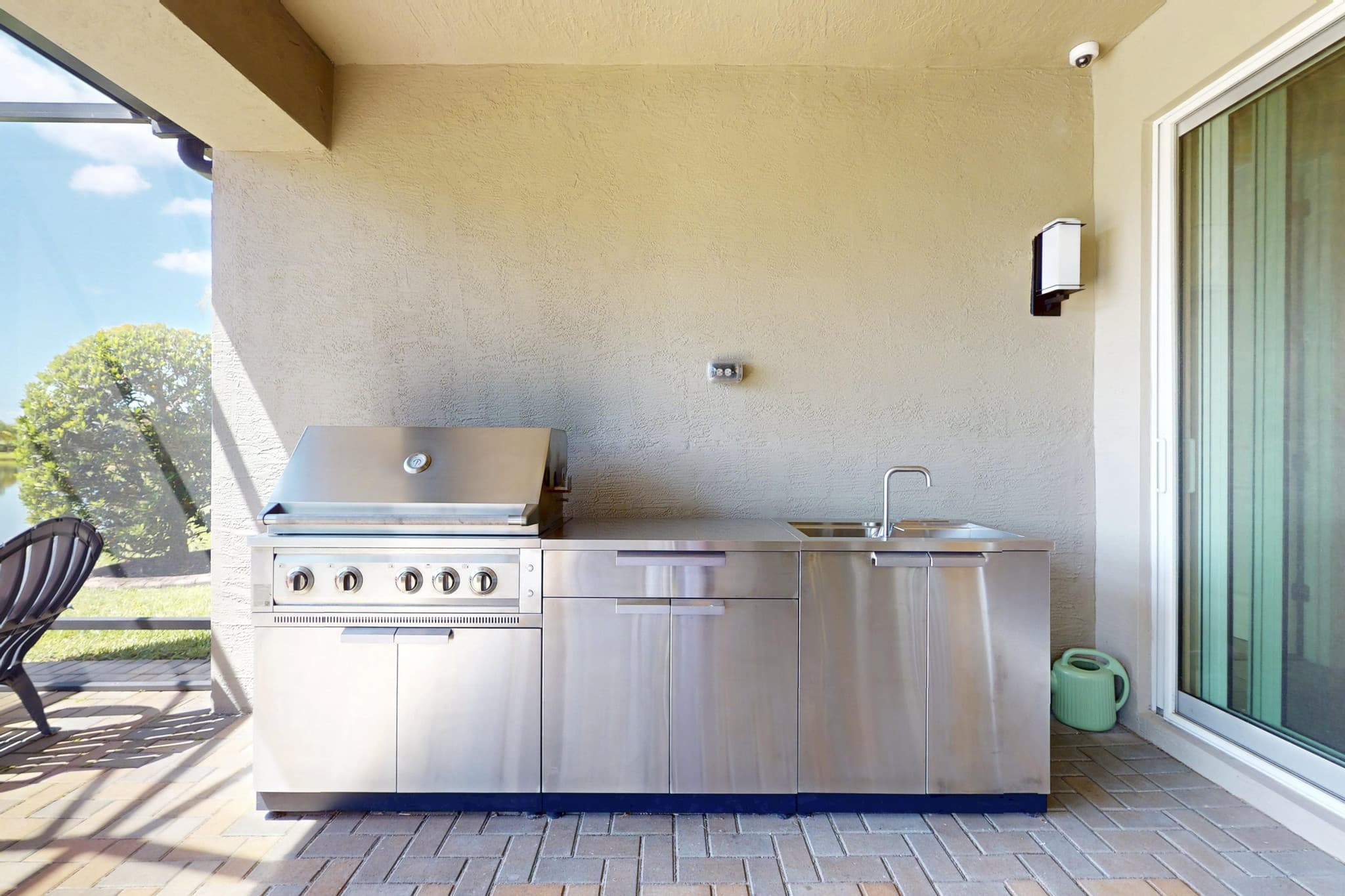 Built-in outdoor summer kitchen with stainless grill