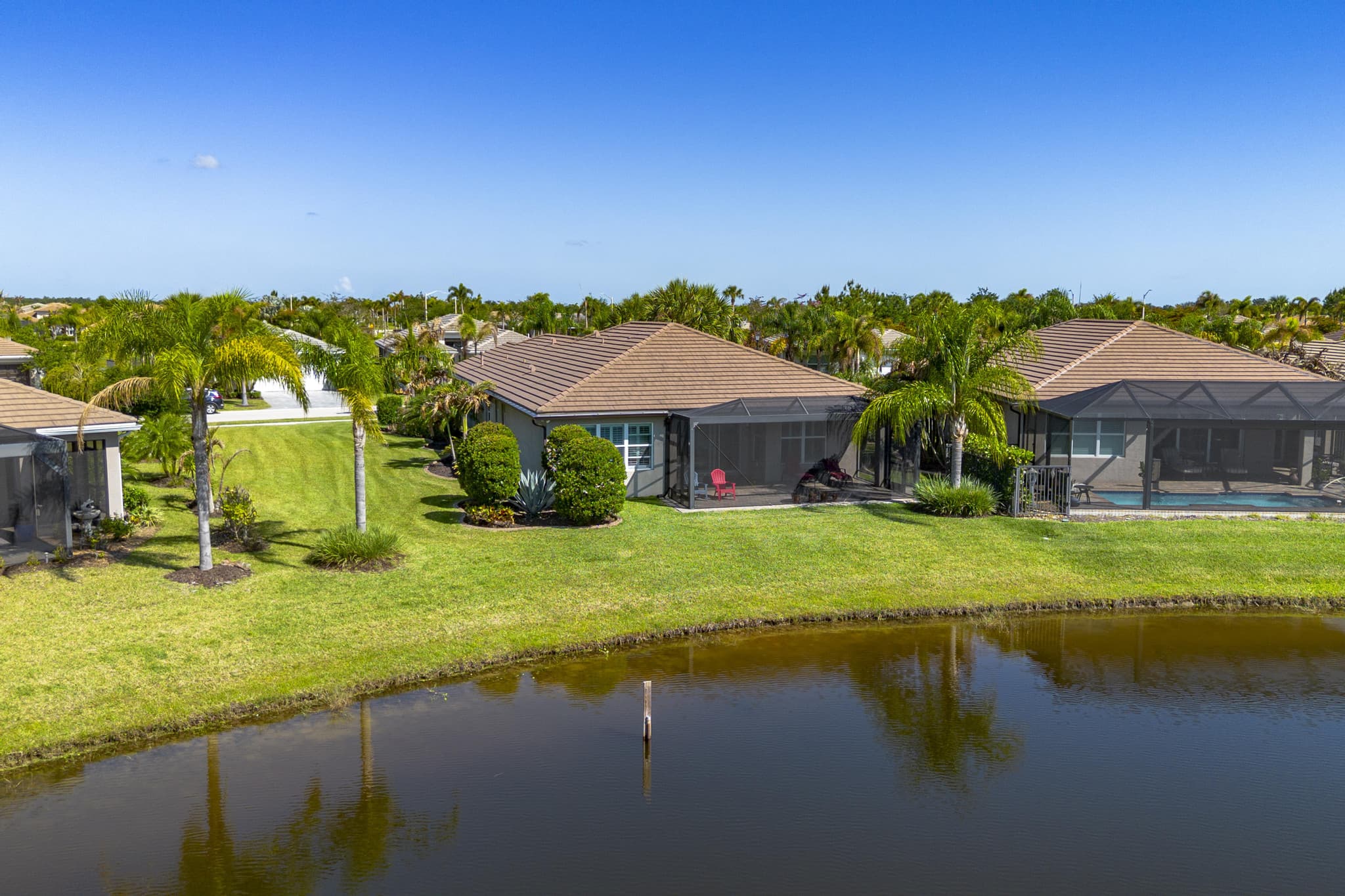 Drone aerial of the backyard and lake frontage