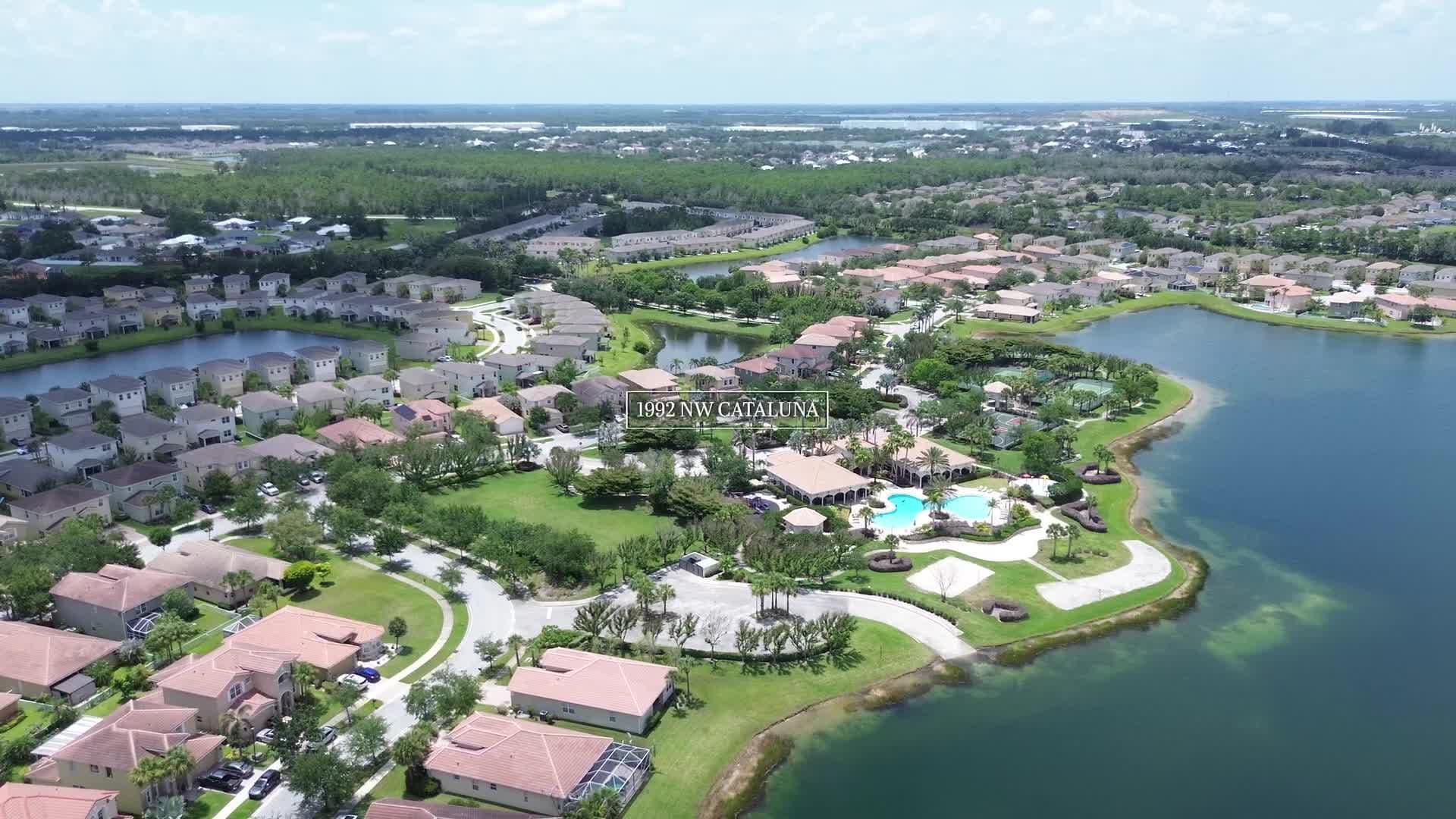 Drone aerial over the lake community surrounding 1992 NW Cataluna Cir