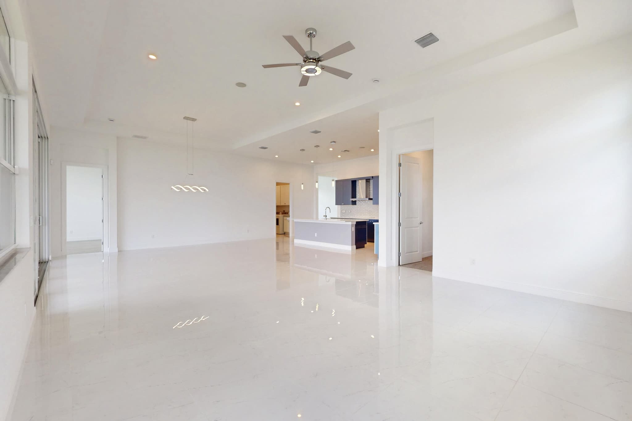 Vacant white great room with tile floors