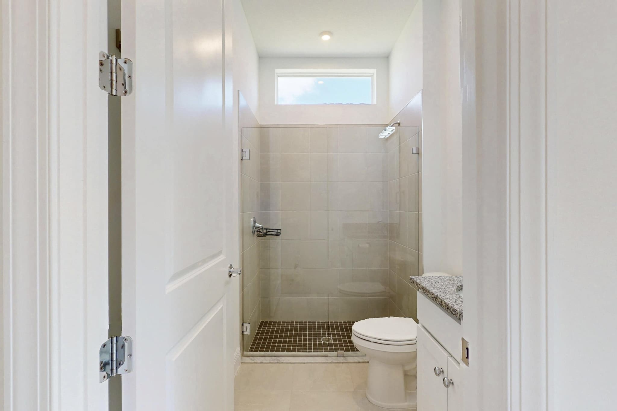 Walk-in tiled shower with glass door