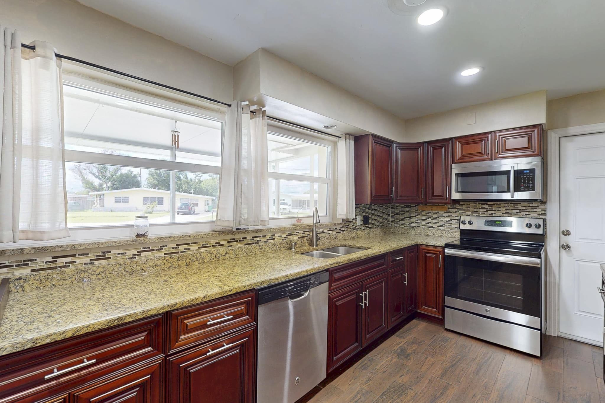 Kitchen with cherry cabinets and granite counters at 613 Beach Ave