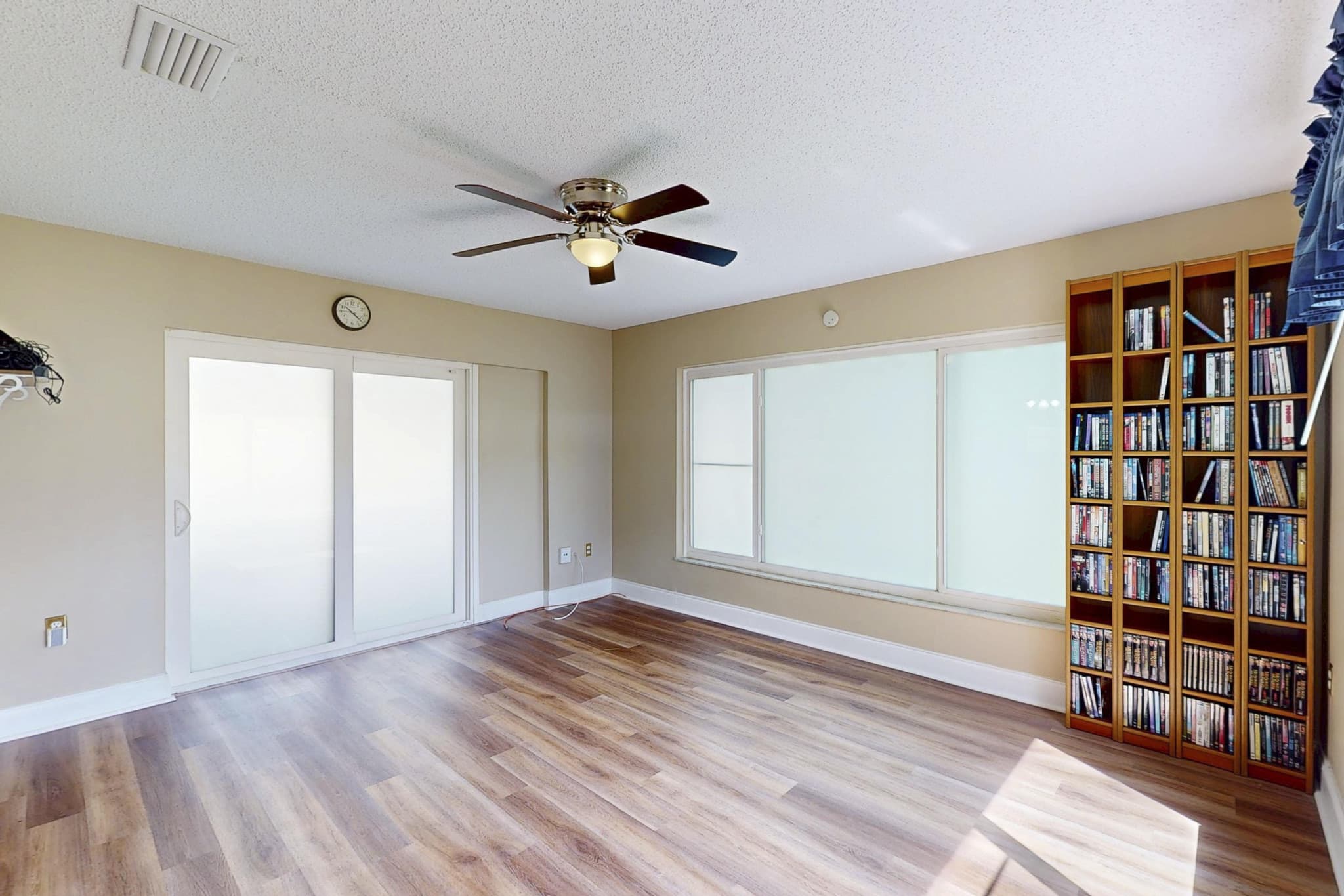 Bright living area with wood-look floors at 613 Beach Ave