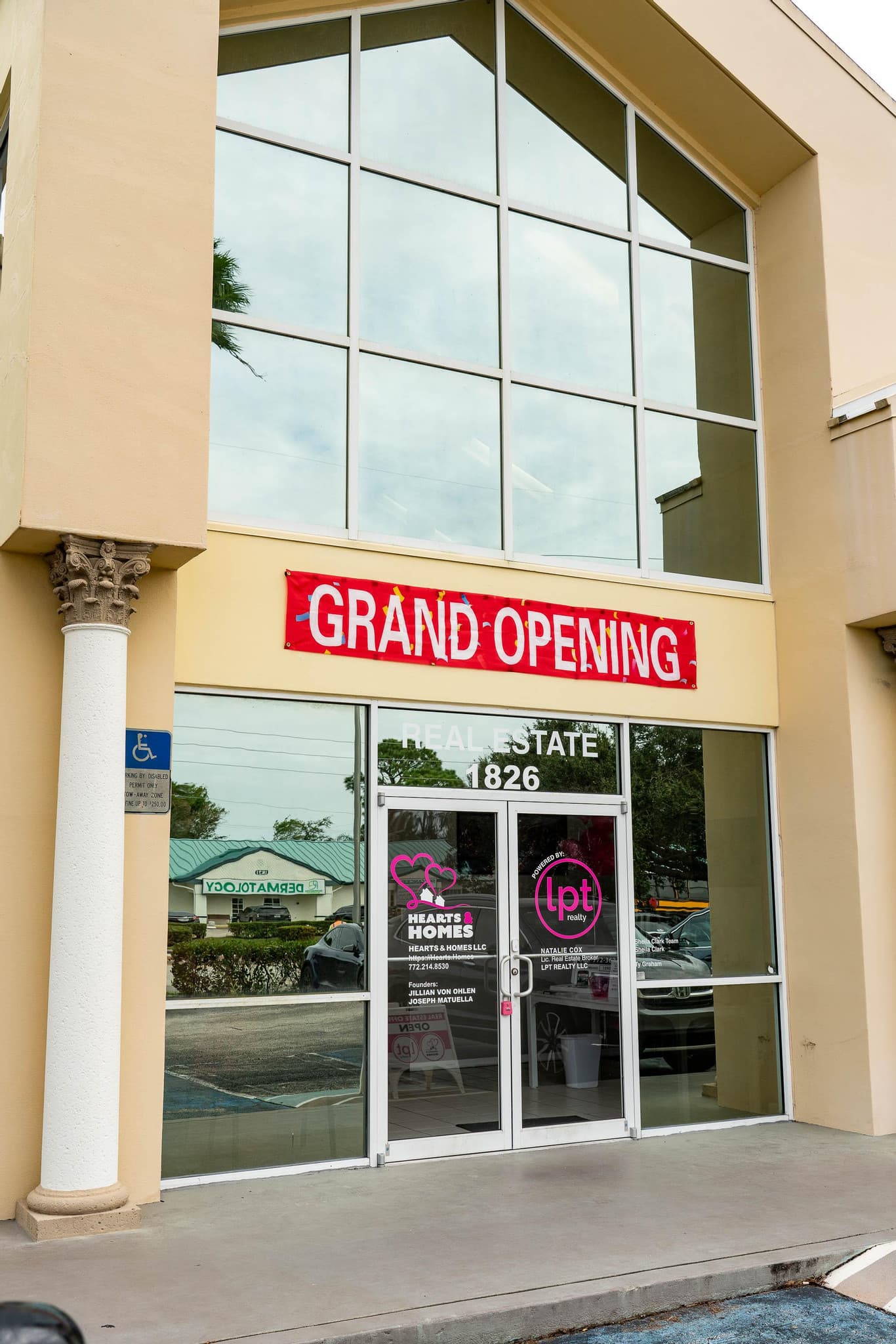 Grand-opening storefront with ribbon and banner, covered by ipixx