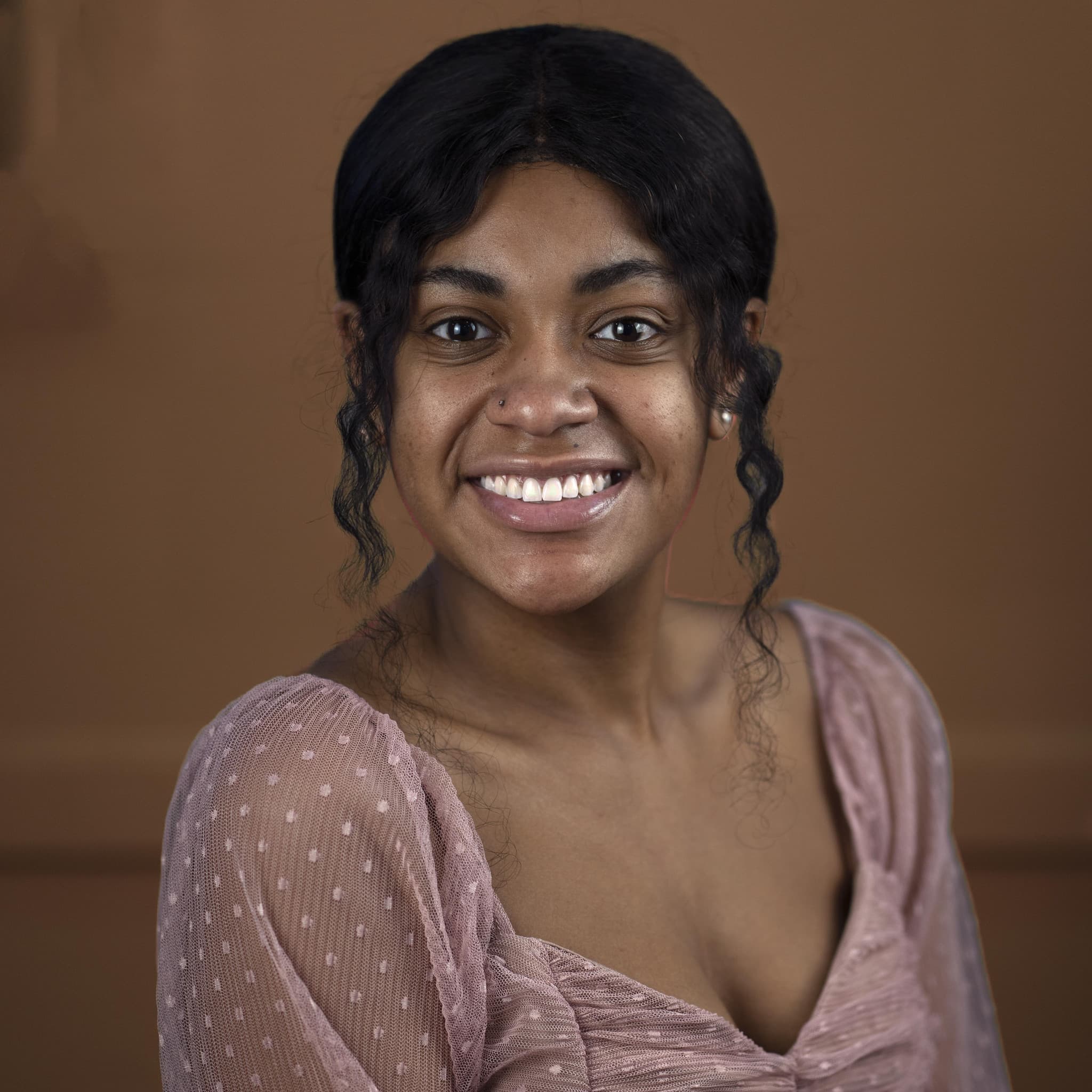Studio headshot on a dark backdrop